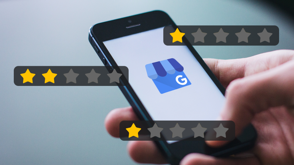 Google Business profile's icon on a smartphone with low-star reviews around the phone.